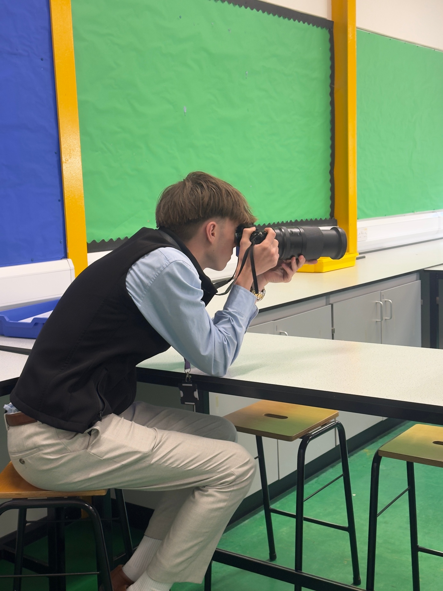 Jack Frampton shooting through a long lens at a Queen's College event
